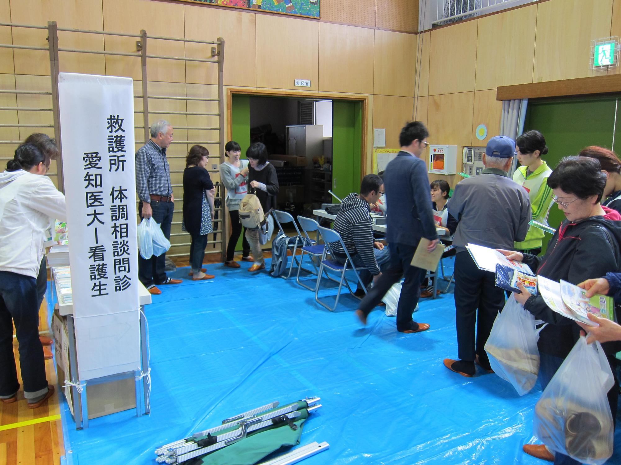体育館の救護所に並ぶ人々の写真