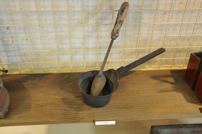 黒色の柄杓の形をした道具と、先端が細くなっているお玉の形をしたコテの写真