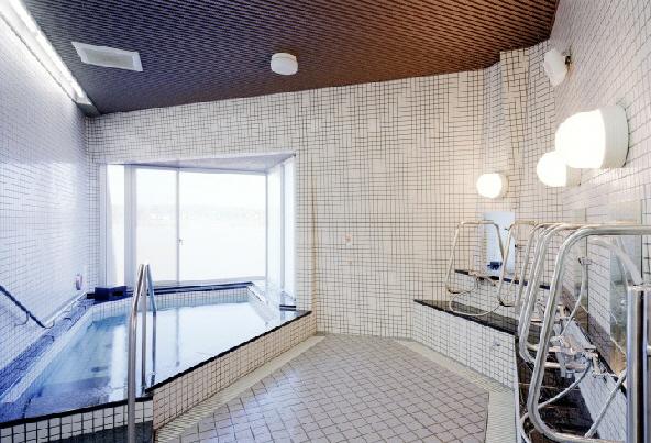 浴槽のはいり口に手すりが設けてあり、シャワーのある洗い場にもそれぞれ1カ所ずつ手すりが設けてある福祉浴室内の写真